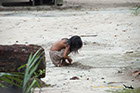 Indian son playing in the dirt Rio Negro River Brazil